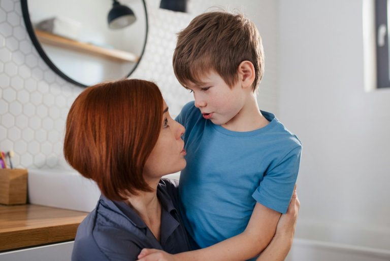 Mother and son A mother gently gazes at her young son in a bright, modern living space.